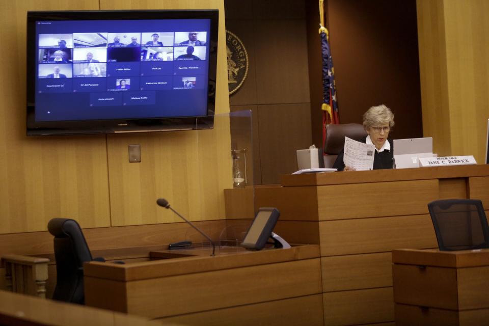 Judge Jane C. Barwick speaks during a bond hearing for former Atlanta police officer Garrett Rolfe who appears on a television screen on Tuesday, June 30, 2020, in Atlanta. Rolfe, who fatally shot Rayshard Brooks can be free on bond while his case is pending. A judge set a bond of $500,000 for Rolfe, who faces charges including felony murder in the killing of the 27-year-old Black man. Rolfe fatally shot Brooks in the back when Brooks fired a Taser in his direction while running away after a struggle on June 12. (AP Photo/Brynn Anderson, Pool)