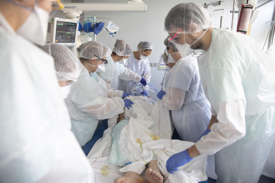 Medical workers tend a patient affected with the COVID-19 in the Nouvel Hospital Civil of Strasbourg, eastern France, Tuesday, Sept.15, 2020. France is grappling with the double headache of trying revive its COVID-battered economy while also curbing the steady climb in infections spread during summer months when vacationers let their guard down and picked up by increased testing. (AP Photo/Jean-Francois Badias)