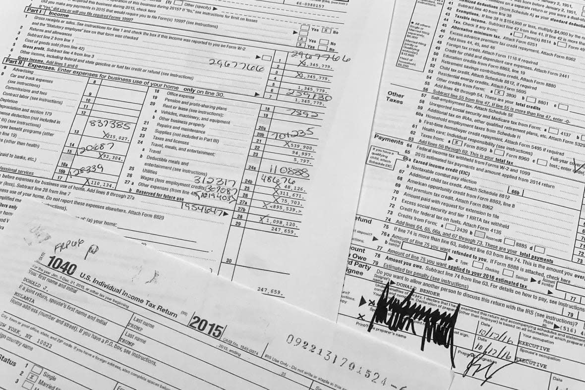 Copies of former President Donald Trump and former first lady Melania Trump individual tax returns for 2015, released by the Democratic-controlled House Ways and Means Committee, are photographed Friday, Dec. 30, 2022. The returns, which include redactions of some personal sensitive information such as Social Security and bank account numbers, span nearly 6,000 pages, including more than 2,700 pages of individual returns, and more than 3,000 pages in returns for Trump’s business entities. (AP Photo/Jon Elswick)