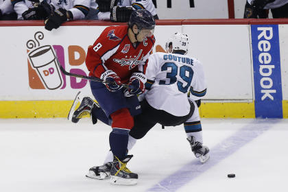 Oct 14, 2014; Washington, DC, USA; Washington Capitals left wing Alex Ovechkin (8) skates with the puck past San Jose Sharks center Logan Couture (39) in the third period at Verizon Center. The Sharks won 6-5 in a shootout. (Geoff Burke-USA TODAY Sports)