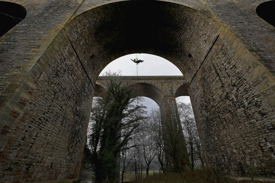 Abseilers descend to clean the Chirk Aqueduct in n Wrexham, Wales