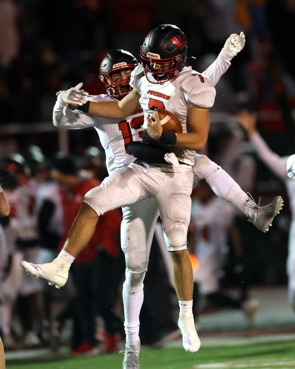 Lakota West quarterback Mitch Bolden (7) celebrates with teammate Ben Minich (13) as the clock runs out in the regional semifinal game between Lakota West and St. Xavier high schools at Princeton High School Nov. 12, 2021. Bolden currently has six offers and Minich's stock is up after a successful track season.