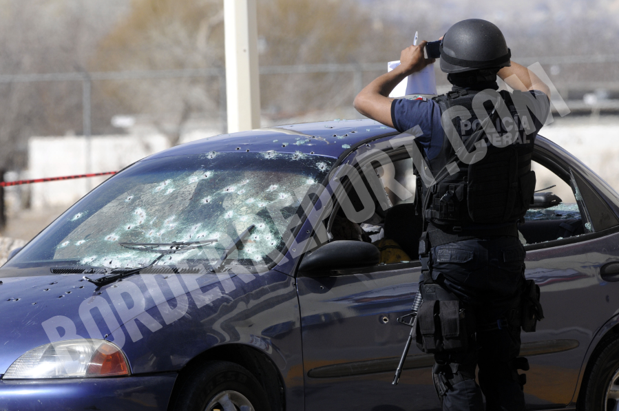 This undated file photo shows a police officer collecting evidence following a shooting in Juarez, Mexico. (Courtesy Lucio Soria)