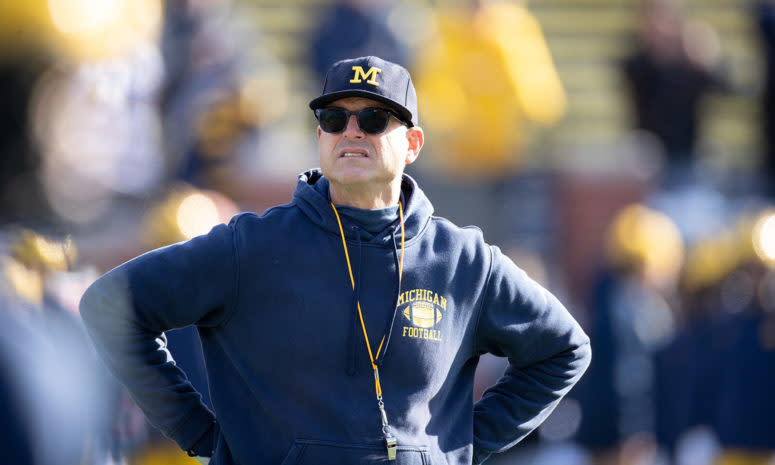 Michigan head coach Jim Harbaugh on the sideline against Michigan State in a Big Ten football rivalry game