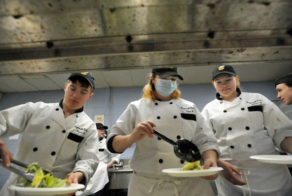 Sampling a Caesar salad and a pea and lemon risotto made by chef Paul Wahlberg are Weymouth High School culinary students, from left, James Keyes, Elliot Johnson and Allison Wilt during a cooking demonstration at Weymouth High School, Monday, April 11, 2022.