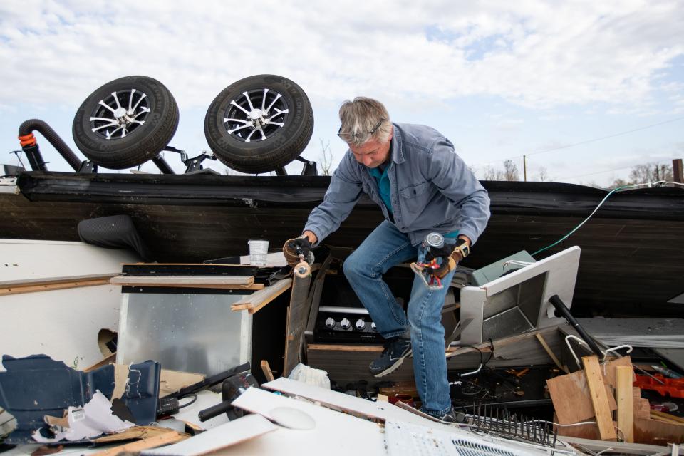 Thad Brown helps his brother sort through rubble and debris for belongings after a tornado ripped through the Florida Caverns RV Resort in Marianna, Florida on Tuesday, Jan. 9, 2024.