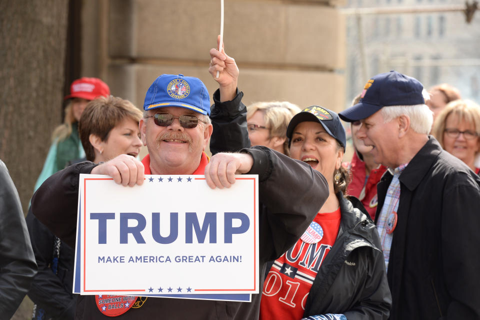 Trump supporters hold up a sign
