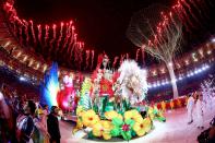 <p>Carnival singers and dancers perform as fireworks explode near the conclusion of the Closing Ceremony on Day 16 of the Rio 2016 Olympic Games at Maracana Stadium on August 21, 2016 in Rio de Janeiro, Brazil. (Photo by Ezra Shaw/Getty Images) </p>