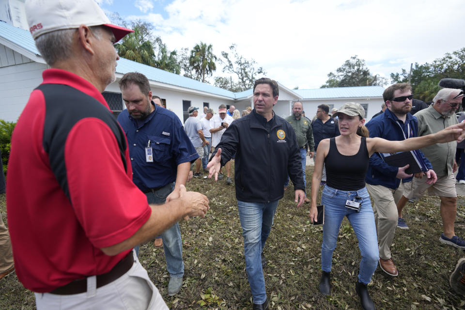 Florida Gov. Ron DeSantis, shakes hands with a man as he visits a church, home, and businesses damaged during the passage of Hurricane Idalia one day earlier, in Horseshoe Beach, Fla., Thursday, Aug. 31, 2023. (AP Photo/Rebecca Blackwell)