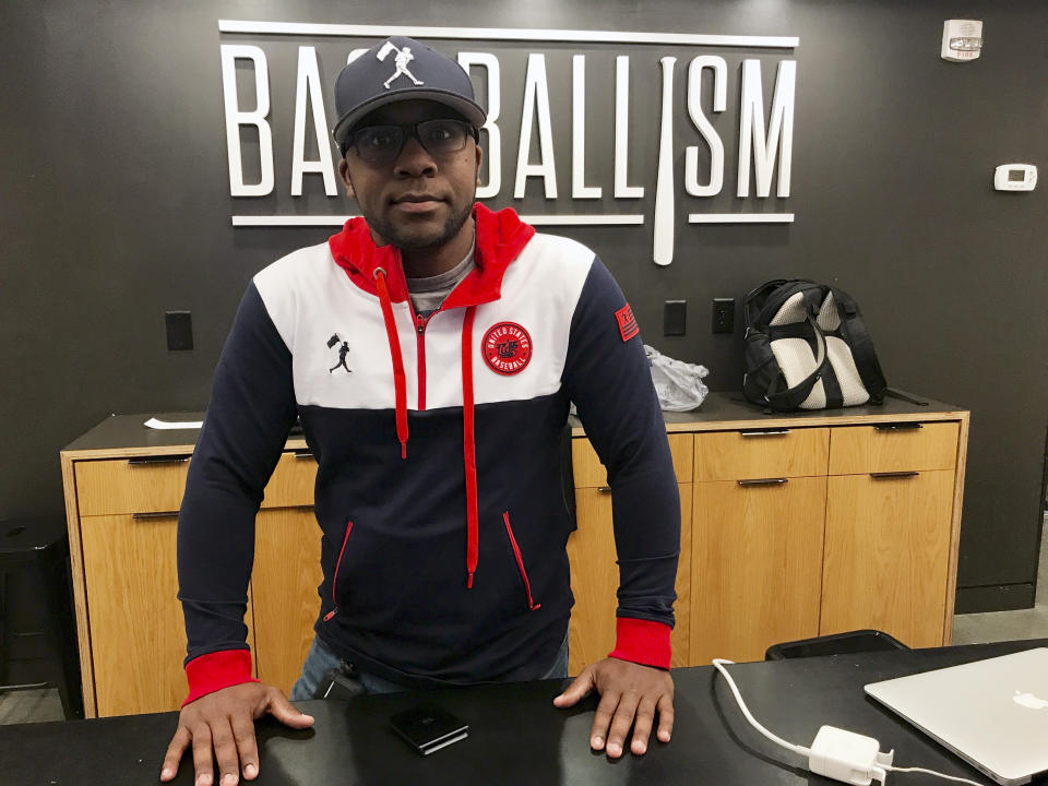 Baseballism store manager Thomas Brown poses Thursday, Oct. 28. 2021, in Atlanta. Brown expects one of the busiest weeks of the year at Baseballism, which sells baseball apparel and other gear related to the national pastime at The Battery, just outside the Atlanta Braves' stadium in Cobb County, Ga. (AP Photo/Jeff Martin)