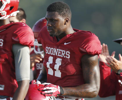 FILE - In this Aug. 5, 2014, file photo, Oklahoma's Dorial Green-Beckham takes a water break during NCAA college football practice in Norman, Okla. (AP Photo/Sue Ogrocki, File)