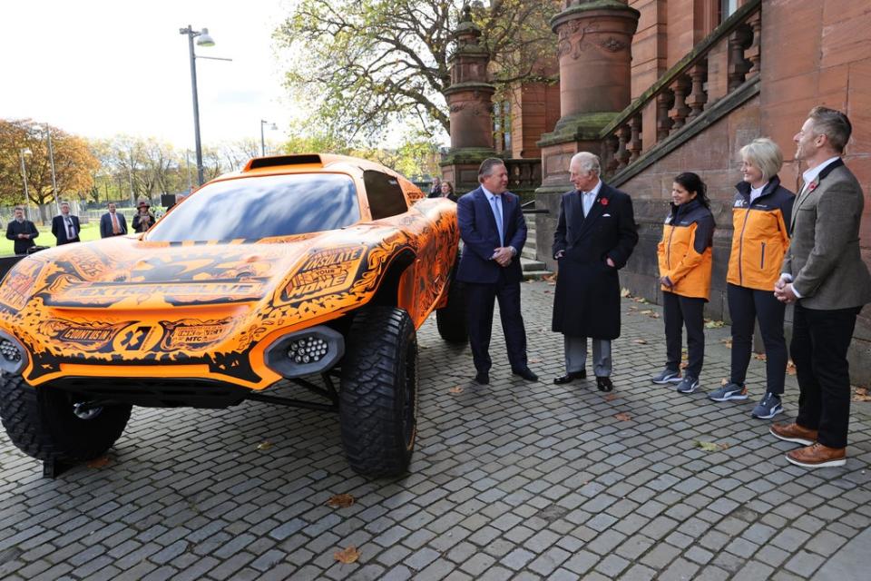 The Prince of Wales (second left) is shown McLaren’s Extreme E car and its new hand-drawn livery, by Zak Brown (left), Chief Executive of McLaren Racing, Leena Gade, McLaren’s female lead engineer and McLaren’s first female driver, Emma Gilmour (second right) Chris Jackson/PA (PA Wire)