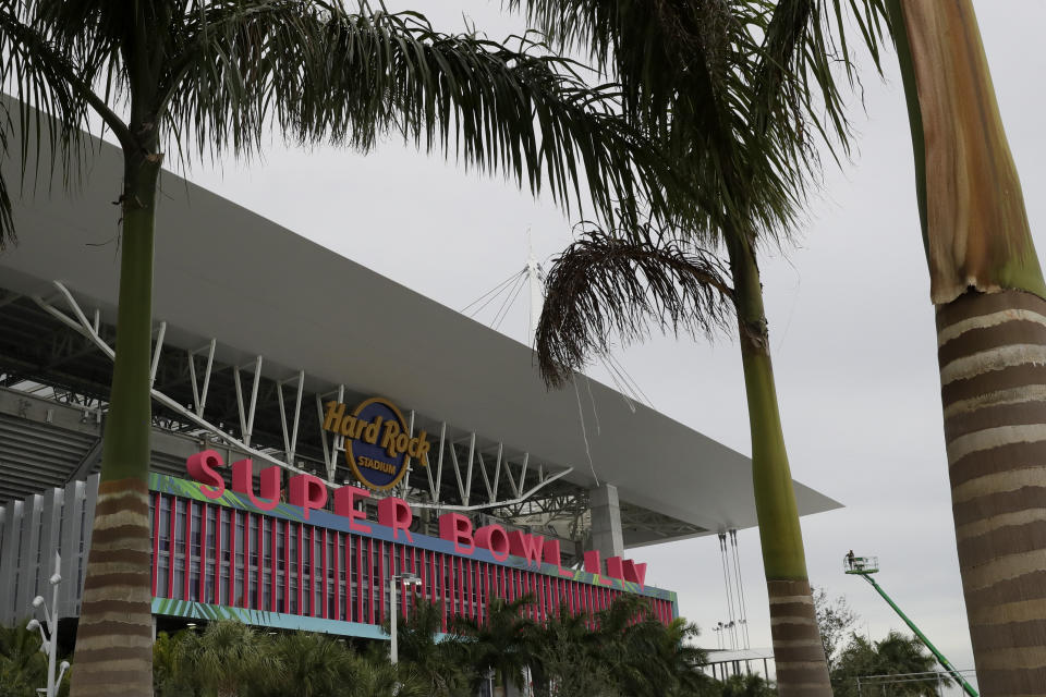 Workers string wire outside of the Hard Rock Stadium Monday, Jan. 27, 2020, in Miami Gardens, Fla. in preparation for the NFL Super Bowl 54 football game. (AP Photo/Chris Carlson)