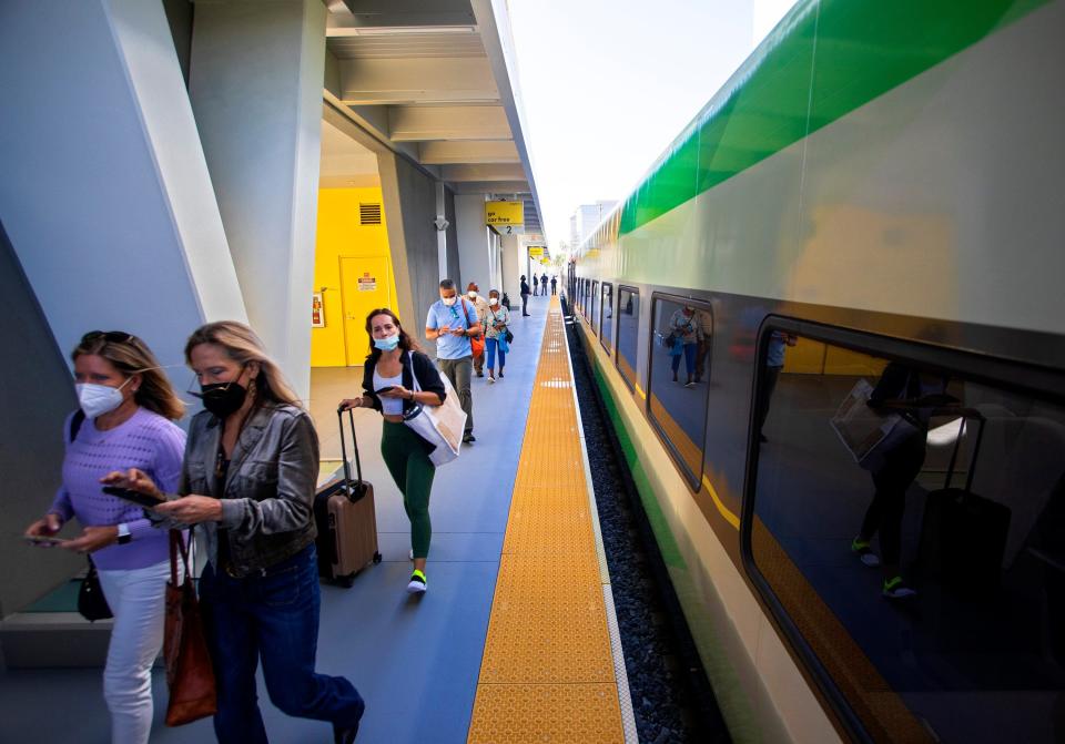 Passengers disembark at the Brightline station in downtown West Palm Beach as the passenger train resumed service between Miami and West Palm Beach Monday, November 8, 2021 after suspending it in March 2020 because of the pandemic. 