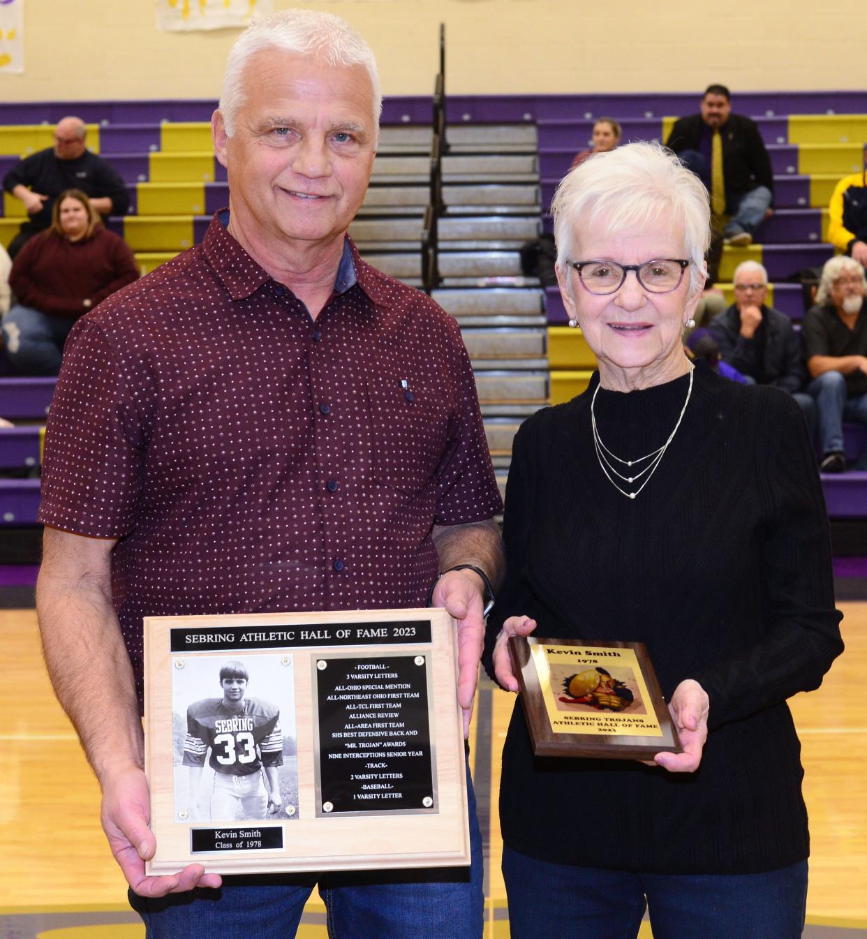 Kevin Smith, left, chose his mother, Diane Smith, as his presenter during his induction into the 2023 Sebring Athletic Hall of Fame ceremony prior to Sebring McKinley's game Friday, Dec. 29, 2023, against Reimer Road Christian at McKinley.