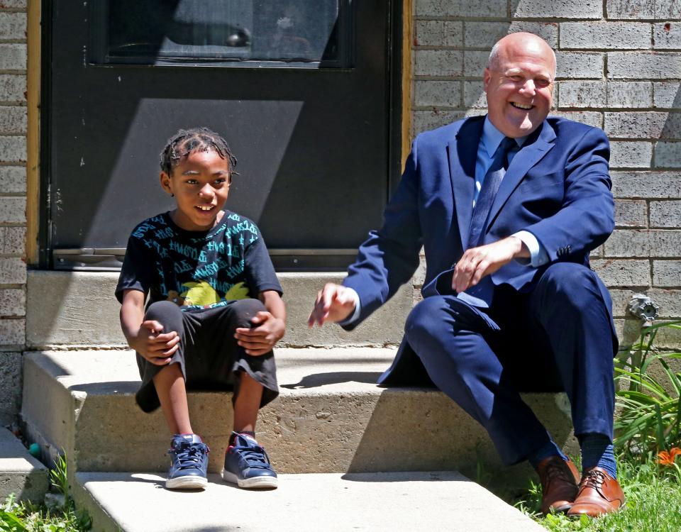 Jamel, 6, left, gets a surprise visit from the White House Infrastructure Coordinator Mitch Landrieu, right, on Wednesday, July 13, 2022, prior to a press conference where Landrieu talked about President Joe Biden bipartisan infrastructure law. Lead pipe replacement construction is underway in front of the youth's home on South 12th street in Milwaukee.