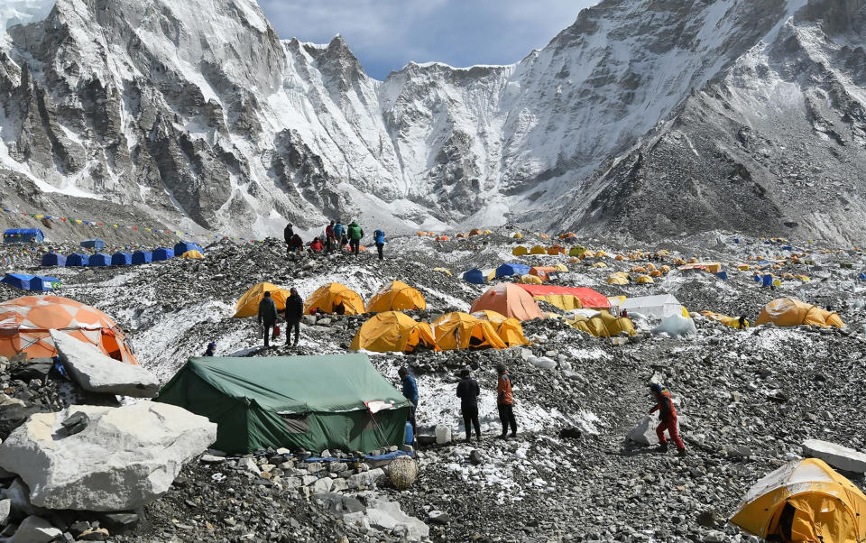 Trekkers and porters gather at Everest Base Camp on April 25, 2018. Hundreds of climbers cleared to scale Everest were acclimating there, officials said, including a record number of Nepali women climbers.