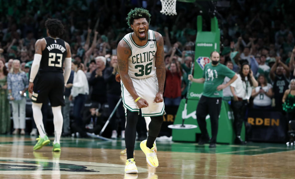 Boston - May 15: The Celtics Marcus Smart reacts after he hit a fourth quarter three pointer to extend the large Boston lead. The Boston Celtics host the Milwaukee Bucks in Game 7 of the Eastern Conference semi-finals between the Celtics and Bucks on May 15, 2022 at TD Garden in Boston. (Photo by Jim Davis/The Boston Globe via Getty Images)