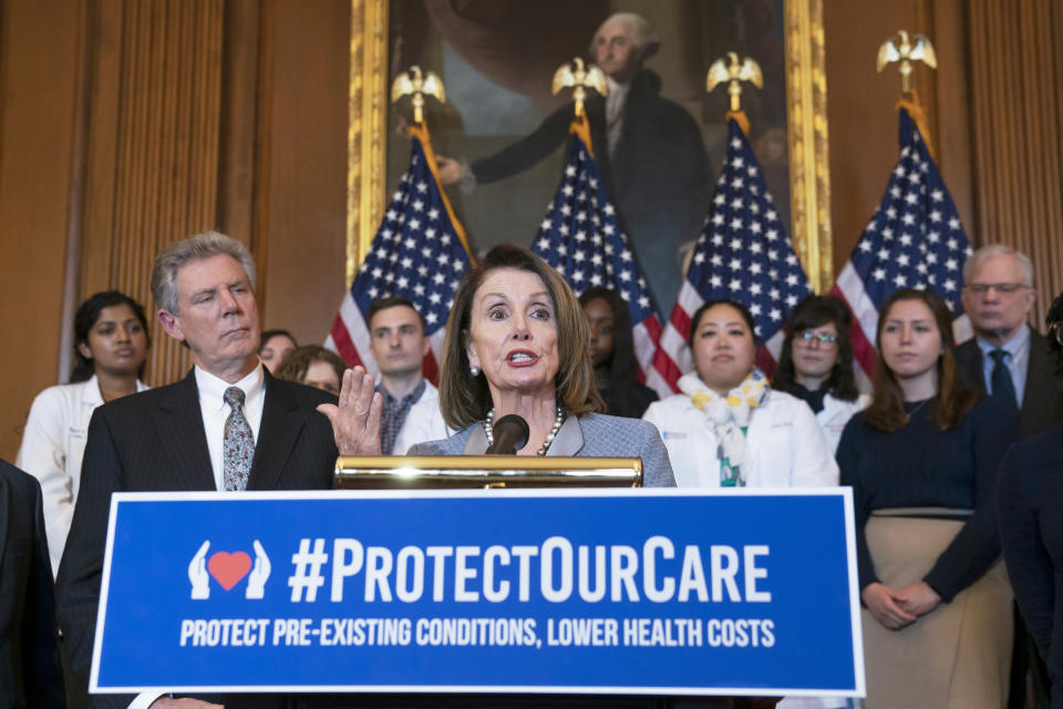 FILE - In this March 26, 2019 file photo, Speaker of the House Nancy Pelosi, D-Calif., joined at left by Energy and Commerce Committee Chair Frank Pallone, D-N.J., speaks at an event to announce legislation to lower health care costs and protect people with pre-existing medical conditions, at the Capitol in Washington. In the campaign for House control, some districts are seeing a fight between Democrats saying they'll protect voters from Republicans willing to take their health coverage away, while GOP candidates are raising specters of rioters imperiling neighborhoods if Democrats win. (AP Photo/J. Scott Applewhite, File)