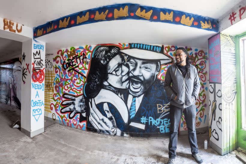 Brandan Odums in front of a portrait of Coretta Scott King and Martin Luther King Jr. in his "Project Be" space in 2013. (Photo: Brandan Odums)