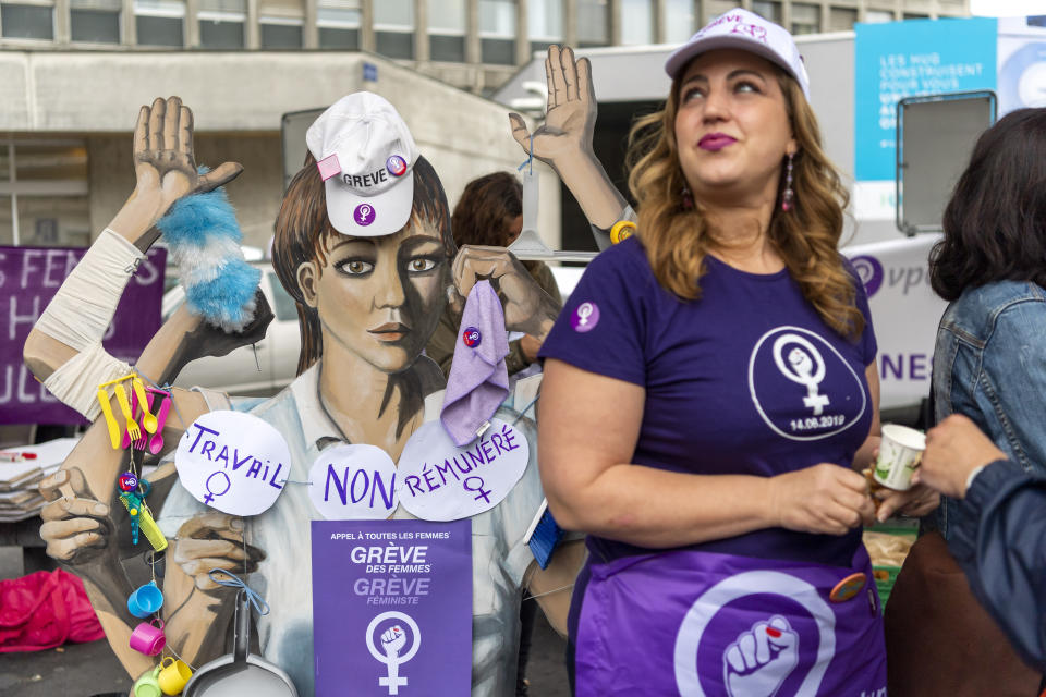 A woman protests in front of the University Hospitals during a nationwide women's strike in Geneva, Switzerland, June 14, 2019. The strike day intends to highlight, among others, unequal wages, pressures on part-time employees, the burden of household work and sexual violence. (Martial Trezzini/Keystone via AP)