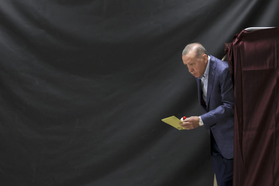 Turkish President Recep Tayyip Erdogan walks out of a voting booth at a polling station in Istanbul, Sunday, May 14, 2023. Turkey is voting Sunday in landmark parliamentary and presidential elections that are expected to be tightly contested and could be the biggest challenge President Erdogan has faced in his two decades in power. (Umit Bektas/Pool Photo via AP)