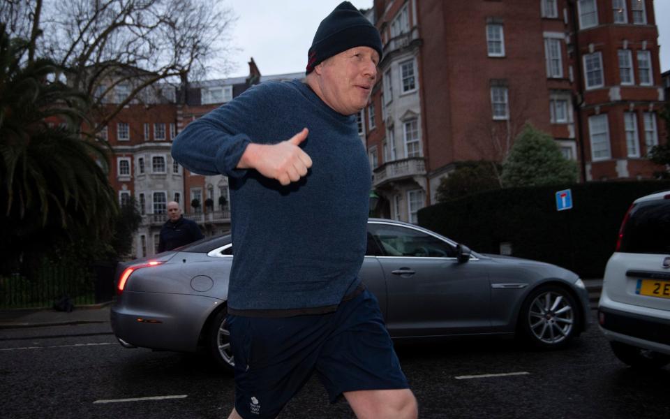 Boris Johnson, the former prime minister, is pictured going for a morning run in central London today - Eddie Mulholland for The Telegraph