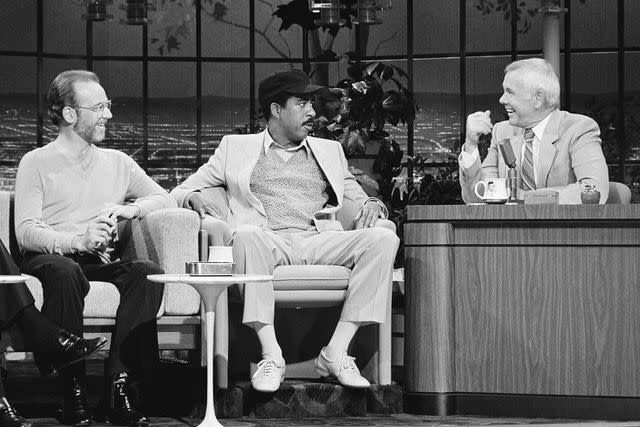<p>Paul Drinkwater/NBCU Photo Bank via Getty</p> George Carlin, Richard Pryor and Johnny Carson in 1981