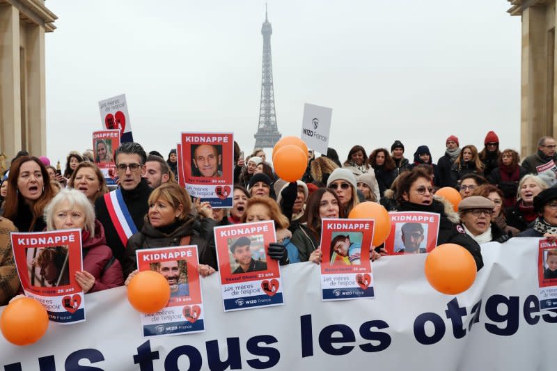 French residents hold placards with portraits of hostages still held in Gaza to demand their immediate release during a rally by Women's International Zionist Organization in front of the Eiffel Tower in Paris on Friday. Photo by Maya Vidon-White/UPI