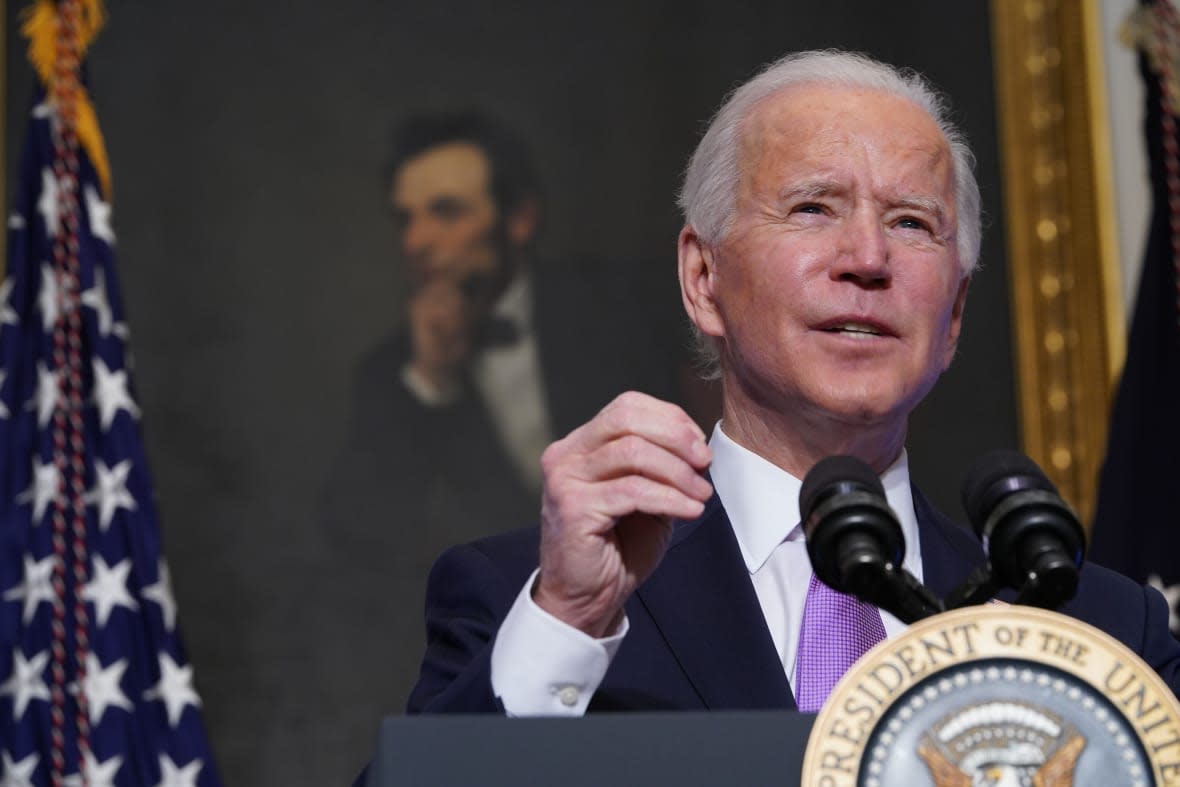 A painting of Abraham Lincoln is seen as US President Joe Biden speaks on Covid-19 response in the State Dining Room of the White House in Washington, DC on January 26, 2021. – The number of confirmed coronavirus cases around the world on January 26 passed 100 million since the start of the pandemic, according to an AFP tally. (Photo by MANDEL NGAN / AFP) (Photo by MANDEL NGAN/AFP via Getty Images)