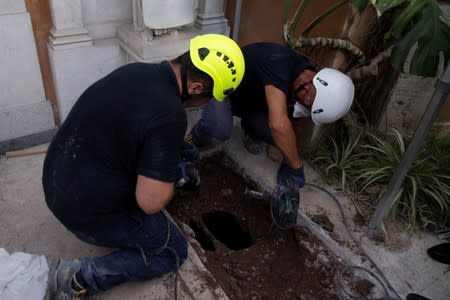 People open tombs in a cemetery on the Vatican's grounds