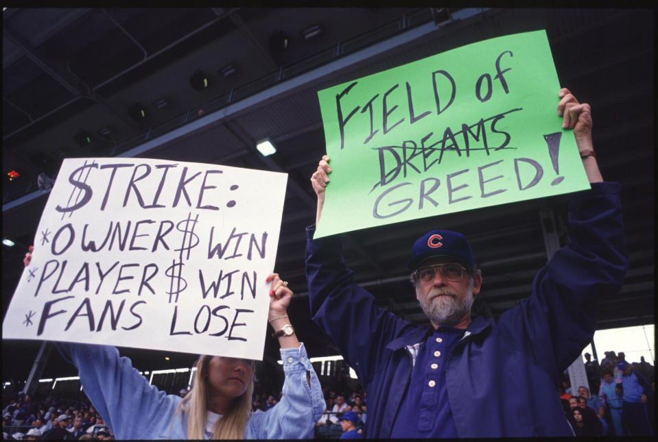 Fans hold up signs in protest of the baseball strike during a game between the San Francisco Giants and the Chicago Cubs in 1994. (Getty Images)