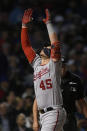 Washington Nationals' Joey Meneses celebrates at home plate after hitting a two-run home run during the eighth inning of baseball game against the Chicago Cubs, Monday, Aug. 8, 2022, in Chicago. (AP Photo/Paul Beaty)