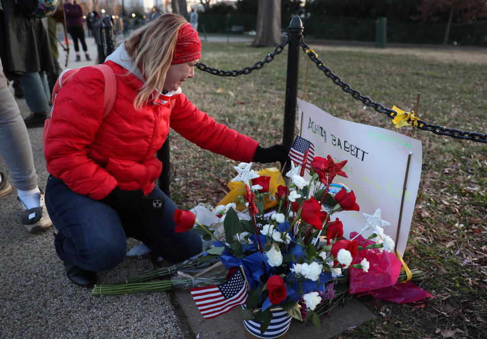 WASHINGTON, DC - JANUARY 07:  Melody Black, from Minnesota, becomes emotional as she visits a memorial setup near the U.S. Capitol Building for Ashli Babbitt who was killed in the building after a pro-Trump mob broke in on January 07, 2021 in Washington, DC. Congress finished tallying the Electoral College votes and Joe Biden was certified as the winner of the 2020 presidential election. (Photo by Joe Raedle/Getty Images)