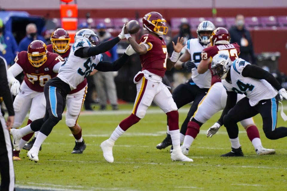 Carolina Panthers defensive end Marquis Haynes (98) puts his hand on the ball as Washington Football Team quarterback Dwayne Haskins (7) passes during the first half of an NFL football game, Sunday, Dec. 27, 2020, in Landover, Md. (AP Photo/Carolyn Kaster)