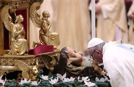 Pope Francis kisses the figure of Baby Jesus as he arrives to lead a mass to mark the World Day of Peace in Saint Peter's Basilica at the Vatican, January 1, 2019. REUTERS/Tony Gentile