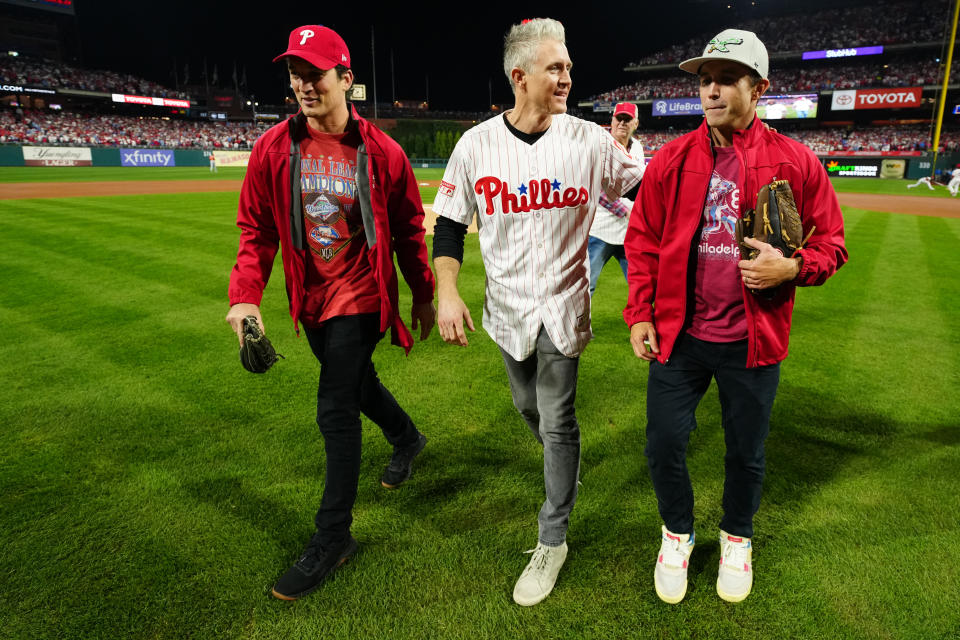 PHILADELPHIA, PA - NOVEMBER 02:  Former Phillies player Chase Utley and actors Miles Teller and Rob McElhenney leave the field after the ceremonial first pitch prior to Game 4 of the 2022 World Series between the Houston Astros and the Philadelphia Phillies at Citizens Bank Park on Wednesday, November 2, 2022 in Philadelphia, Pennsylvania. (Photo by Daniel Shirey/MLB Photos via Getty Images)