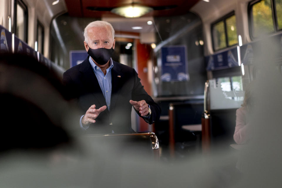 Democratic presidential candidate former Vice President Joe Biden speaks with invited guests aboard an Amtrak train, Wednesday, Sept. 30, 2020, as it makes its way to Alliance, Ohio. Biden is on a train tour through Ohio and Pennsylvania today. (AP Photo/Andrew Harnik)