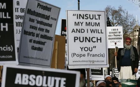 Muslim demonstrators hold placards during a protest against the publication of cartoons depicting the Prophet Mohammad in French satirical weekly Charlie Hebdo, near Downing Street in central London February 8, 2015. REUTERS/Stefan Wermuth