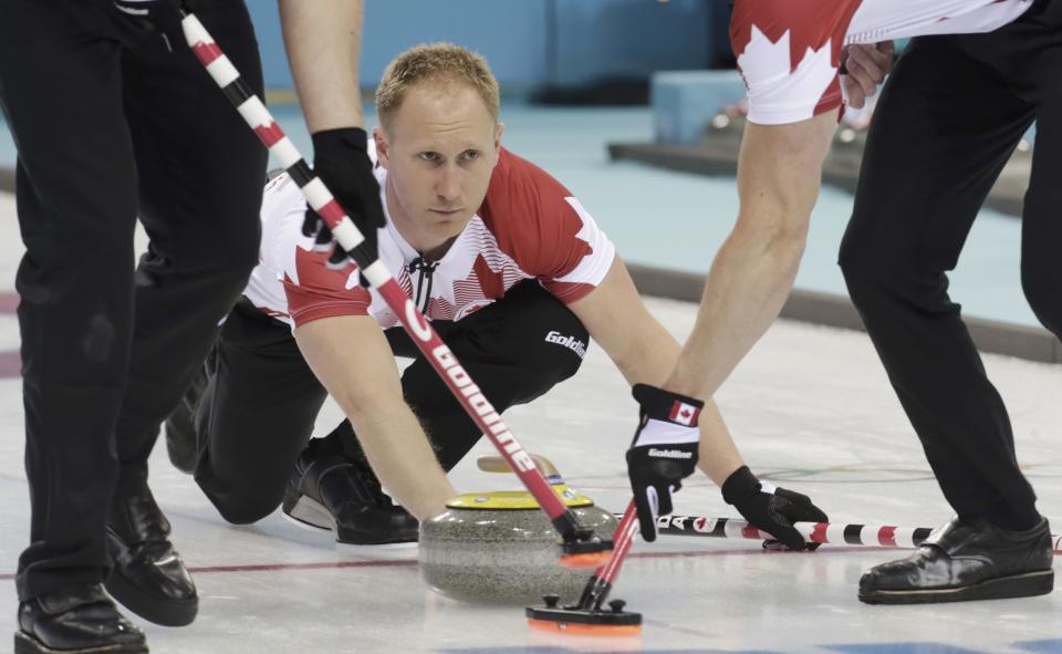Canada's skip Jacobs Brad delivers a stone during their men's curling round robin game against the U.S. in the Ice Cube Curling Centre at the Sochi 2014 Winter Olympic Games February 16, 2014. REUTERS/Ints Kalnins (RUSSIA - Tags: SPORT OLYMPICS SPORT CURLING)