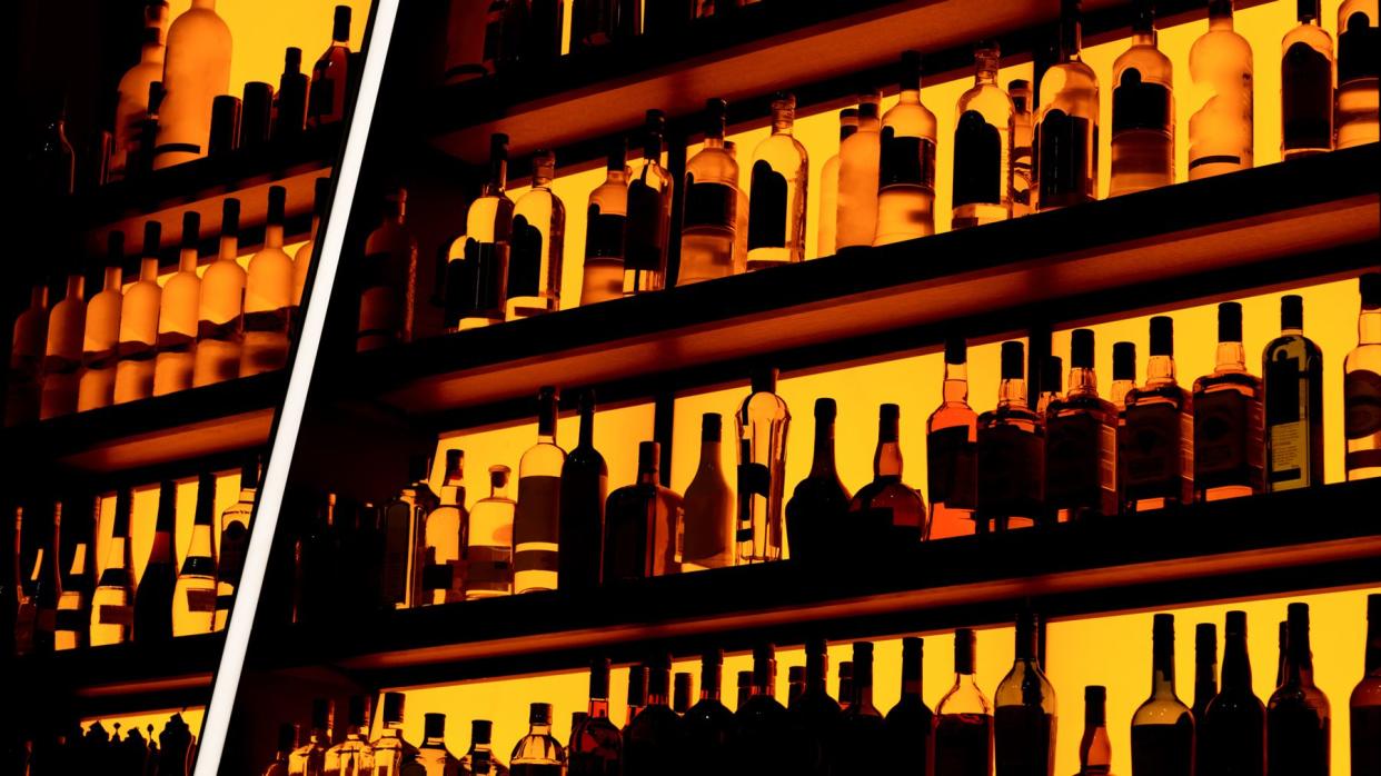 Rows of bottles sitting on shelf in a bar