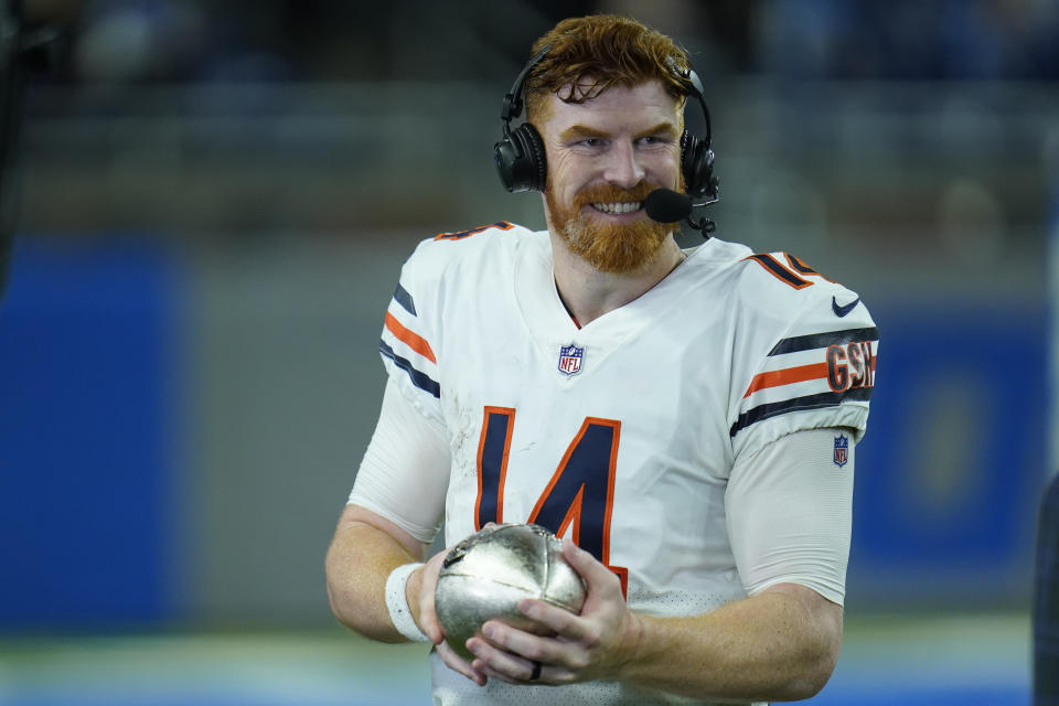 Chicago Bears quarterback Andy Dalton holds a silver football trophy after the second half of an NFL football game against the Detroit Lions, Thursday, Nov. 25, 2021, in Detroit. (AP Photo/Paul Sancya)