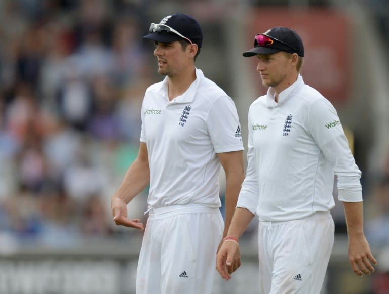 England's captain Alastair Cook (L) and England's Joe Root prepare to bat on July 24, 2016