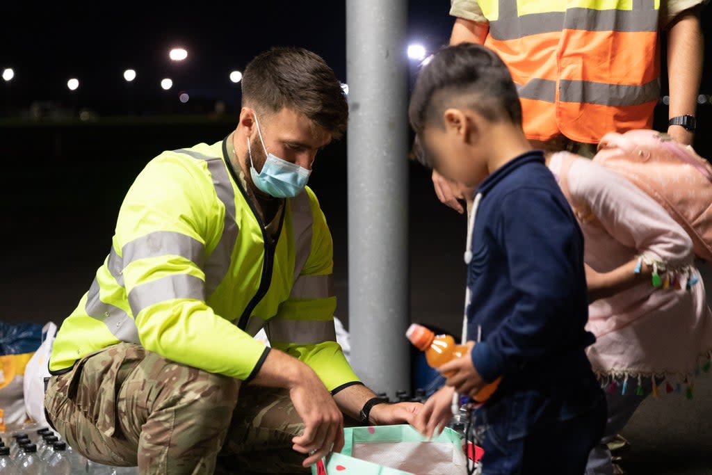 Handout photo issued by the Ministry of Defence (MoD) of military personnel handing out food, drink, toys, and blankets during Op PITTING at RAF Brize Norton. (Cpl Will Drummee RAF/MOD/Crown copyright/PA) (PA Media)