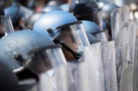 Police stand with riot shields on W. North Avenue in Baltimore, Maryland, April 28, 2015