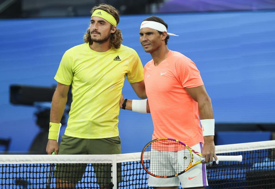 Spain's Rafael Nadal, right, and Greece's Stefanos Tsitsipas pose for a photo ahead of their quarterfinal match at the Australian Open tennis championship in Melbourne, Australia, Wednesday, Feb. 17, 2021.(AP Photo/Hamish Blair)