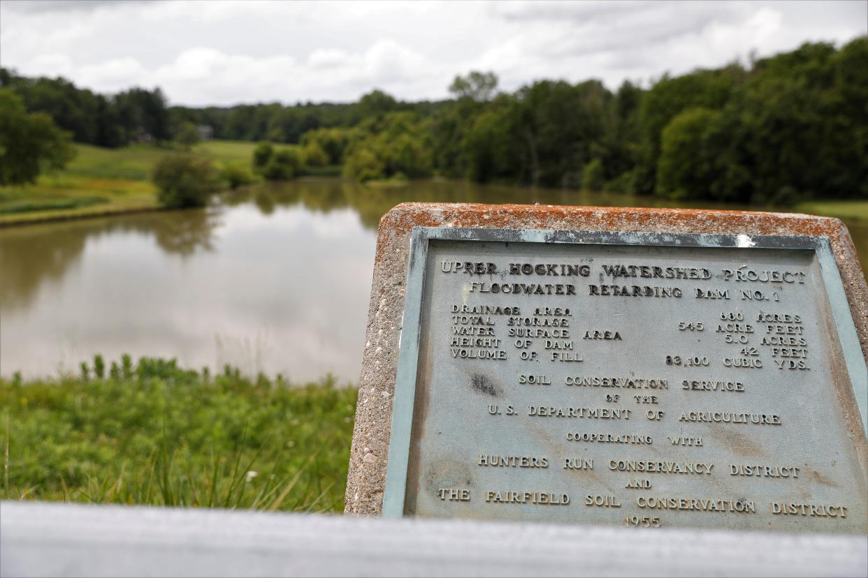 A plaque describes Dam No. 1 on Mt. Zion Road in Hocking Township. The dam is a part of the Hunter's Run Conservancy District, an organization that maintains a network of more than 20 dams in the Hocking River watershed.