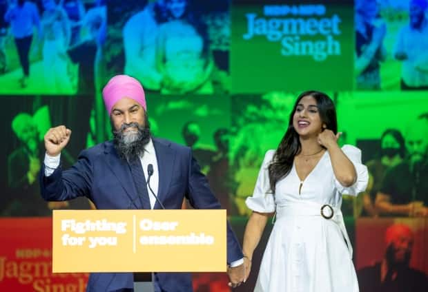 NDP Leader Jagmeet Singh and his wife, Gurkiran Kaur Sidhu, arrive on stage to deliver his concession speech at his election night headquarters in Vancouver on Monday. (Jonathan Hayward/The Canadian Press - image credit)