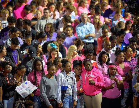 People gather during a candlelight vigil at Lafayette High School for Trinity Gay, the daughter of Olympic sprinter Tyson Gay, who died in an exchange of gunfire early Sunday morning, in Lexington, Kentucky, October 17, 2016. REUTERS/Bryan Woolston