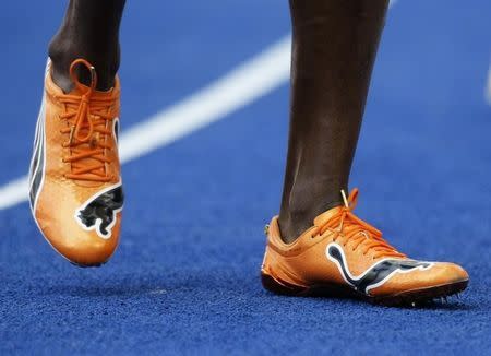 Usain Bolt of Jamaica sports new running shoes after the ninth men's 100 metres heats during the world athletics championships at the Olympic stadium in Berlin, August 15, 2009. REUTERS/Michael Dalder